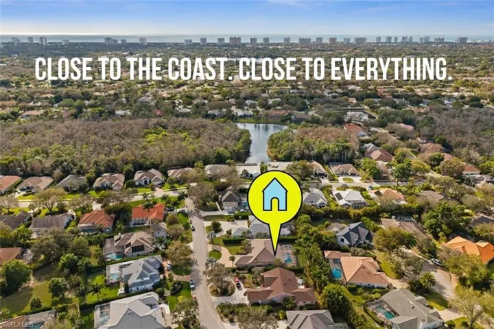 Aerial view of property and surrounding area with a large body of water and nearby suburban area