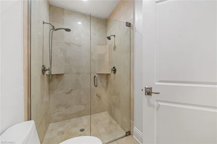 Bathroom featuring toilet and a shower stall