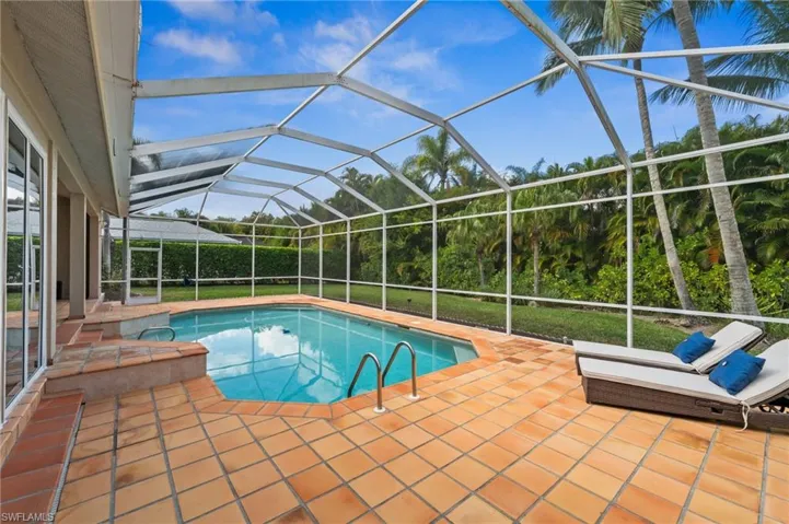 Swimming pool with a sunroom, a lanai, and a patio