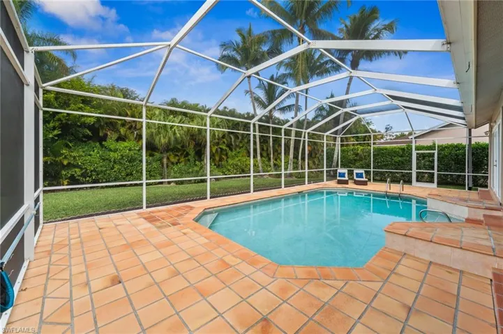 Outdoor pool with a sunroom, a patio area, and a lanai