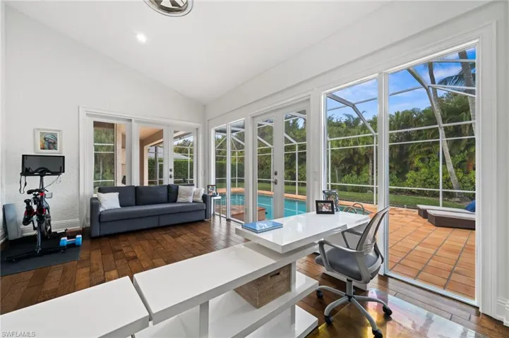 Sun Room Of Primary Bedroom Office featuring dark wood-type flooring, vaulted ceiling, a sunroom, french doors, and recessed lighting
