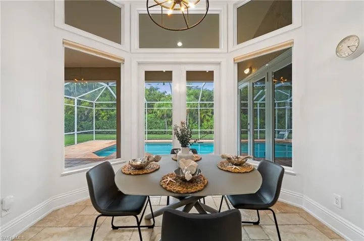 Dining room with a chandelier and a high ceiling