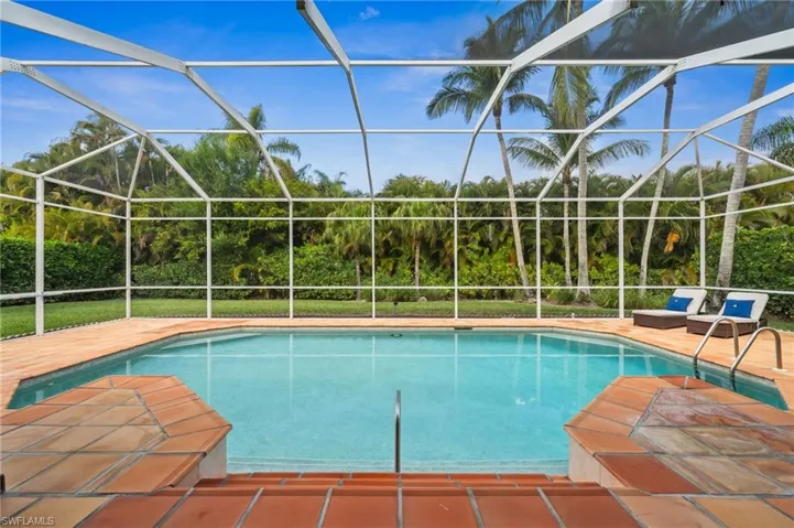 Swimming pool featuring a sunroom and a lanai