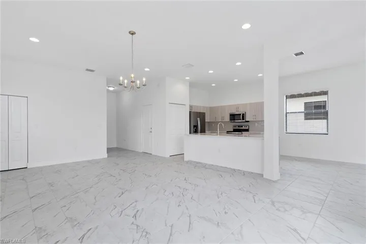 Different angle of living room featuring tile  flooring, and recessed lighting.