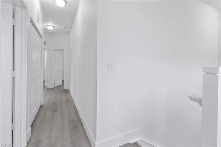 Upstairs hallway featuring wood-style flooring