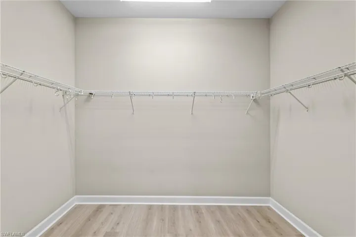 Spacious closet with light wood-type flooring