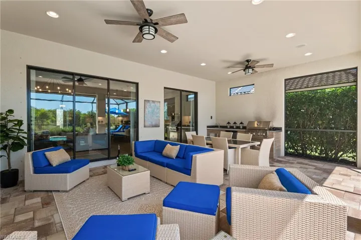 View of patio / terrace featuring grilling area, an outdoor hangout area, exterior kitchen, and ceiling fan