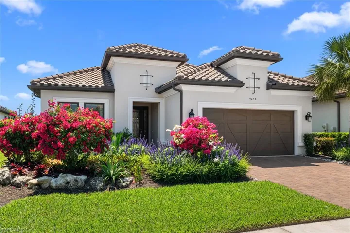 Mediterranean / spanish home featuring a tile roof, decorative driveway, a garage, and stucco siding