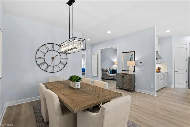Dining room with baseboards, recessed lighting, and light wood-type flooring
