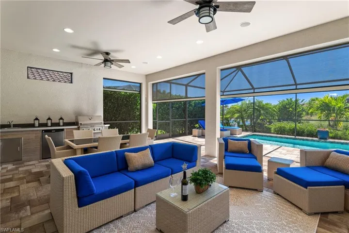 View of patio / terrace featuring an outdoor hangout area, an outdoor kitchen, a lanai, and a sink