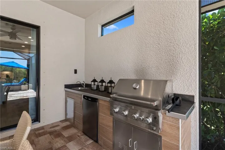 View of patio / terrace featuring grilling area, exterior kitchen, and a sink