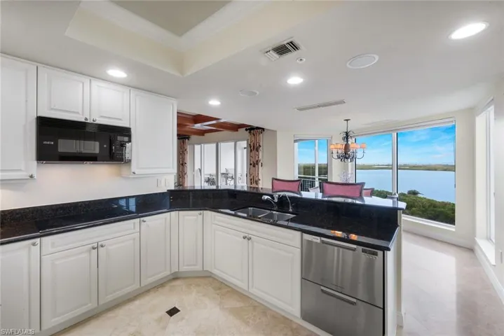 The kitchen has been refreshed with newly painted upgraded wood cabinets.
