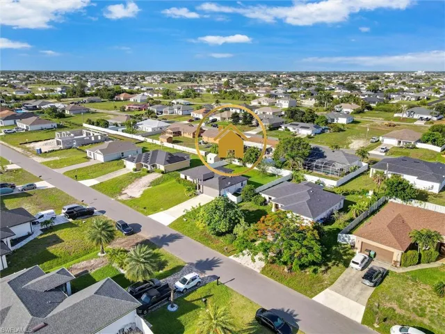 Aerial perspective showcasing a residential neighborhood with single-story homes and undeveloped lots