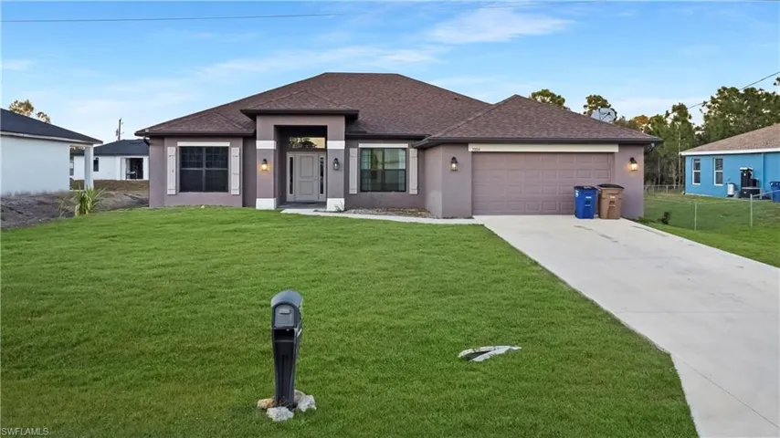 View of front of property featuring stucco siding, concrete driveway, roof with shingles, and an attached garage