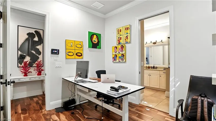 Office area featuring crown molding and light wood-style floors - Virtually Edited Image