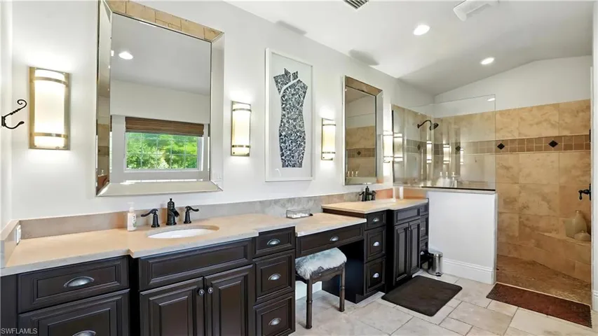 Full bath with walk in shower, double vanity, lofted ceiling, recessed lighting, and light tile patterned flooring - Virtually Edited Image