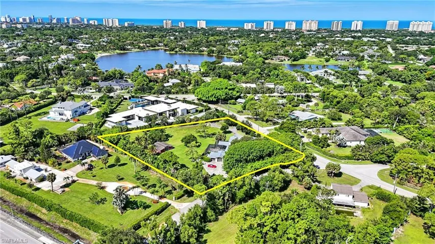 View of property location with a nearby body of water, skyline, and property parcel outlined - Virtually Edited Image