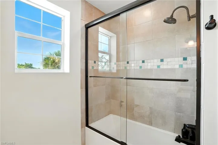 Full bath featuring enclosed tub / shower combo - Virtually Edited Image