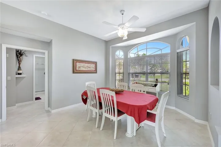 Tiled dining space featuring ceiling fan