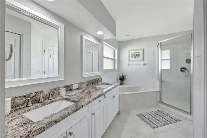 Bathroom with tile patterned flooring, vanity, and independent shower and bath