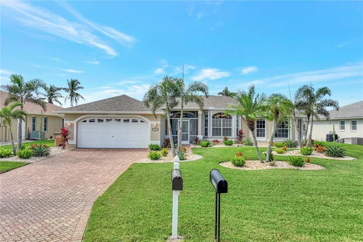 Single story home featuring a front yard and a garage