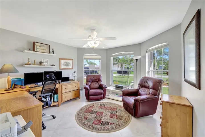 Tiled office space featuring ceiling fan