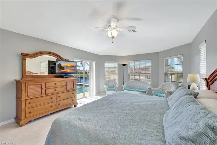 Bedroom featuring access to outside, ceiling fan, and light tile patterned floors