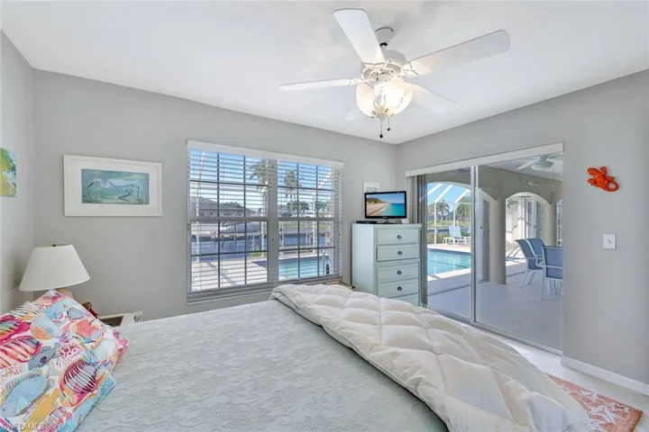 Bedroom with access to exterior and ceiling fan