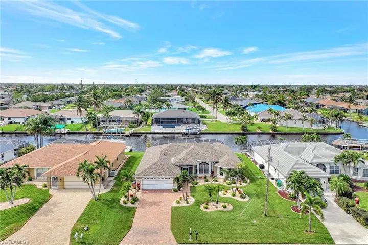 Birds eye view of property with a water view