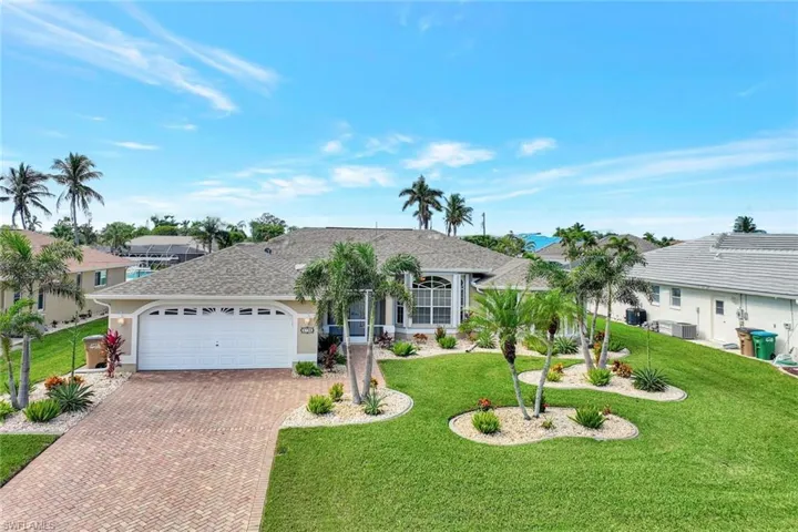 Single story home with a front yard and a garage