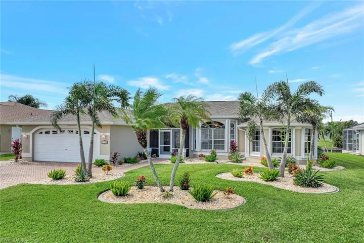 Single story home featuring a front lawn and a garage