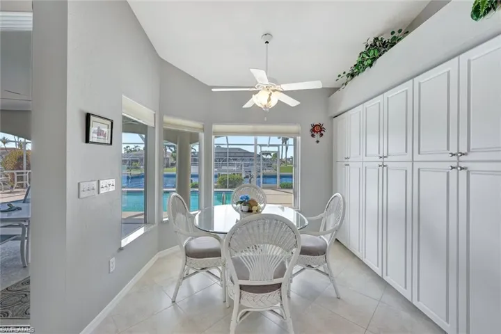 Tiled dining area featuring ceiling fan