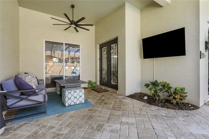 View of exterior entry featuring a patio, a ceiling fan, and stucco siding