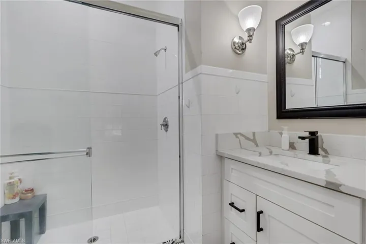 Bathroom featuring vanity and a stall shower