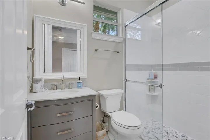 Bathroom with vanity and a stall shower