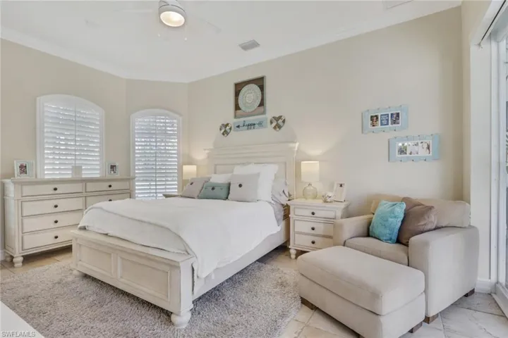 Bedroom with ornamental molding and a ceiling fan