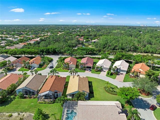 Aerial view of rear of home and large side yard