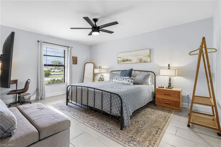 Recessed lighting, ceiling fan, and light-toned walls create an inviting ambiance