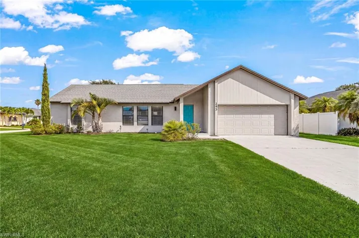 Single-story residence featuring a two-car garage, a concrete driveway, and a light-colored stucco exterior