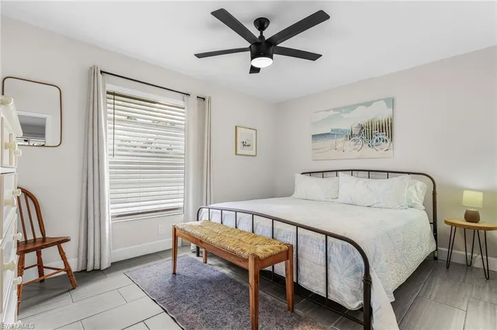 Interior room featuring light gray walls and wood-finish tile flooring