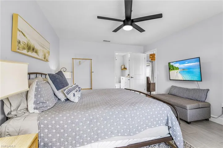 Bedroom featuring light gray walls and wood-finish flooring