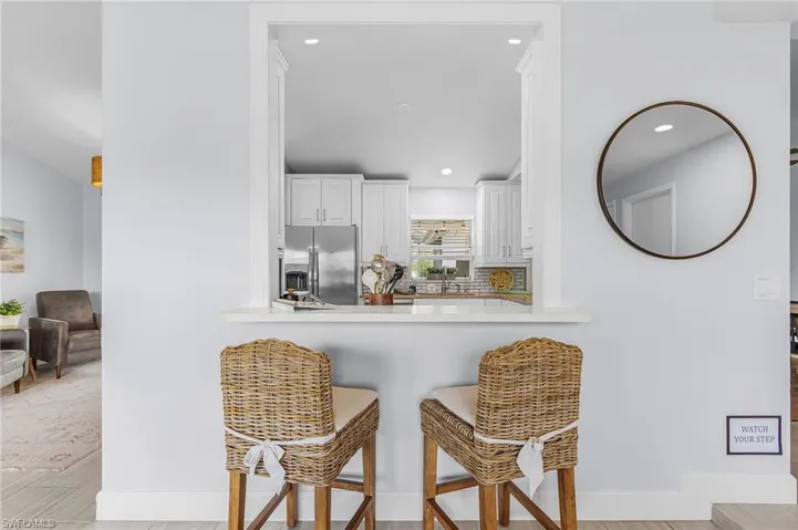 Kitchen pass-through with a white countertop and recessed lighting