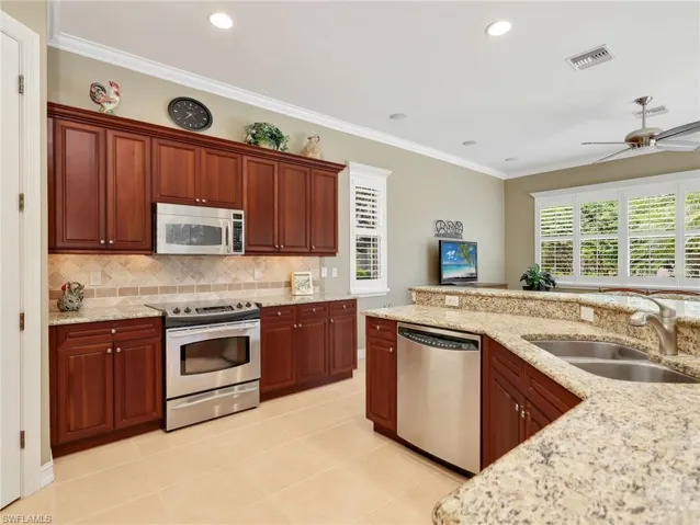 Kitchen with 42" Cabinetry, Stainless Steel Appliances and Sink, Granite Countertops, Tile Backsplash, Breakfast Bar & Pantry