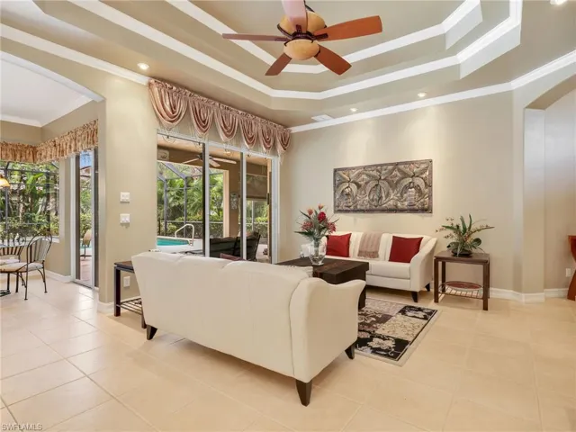 Formal Living Room & Eat-In Kitchen with Sliders to the Screened-In Lanai with a Pool View from Both Rooms