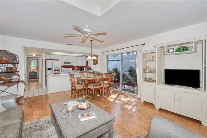 Living room with ceiling fan and light hardwood / wood-style flooring