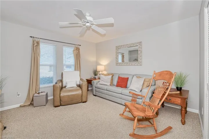 Living room with ceiling fan and carpet