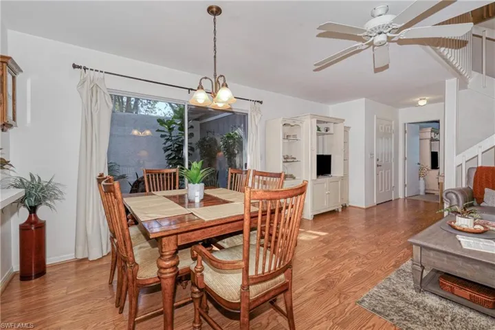 Dining room with light hardwood / wood-style flooring and ceiling fan