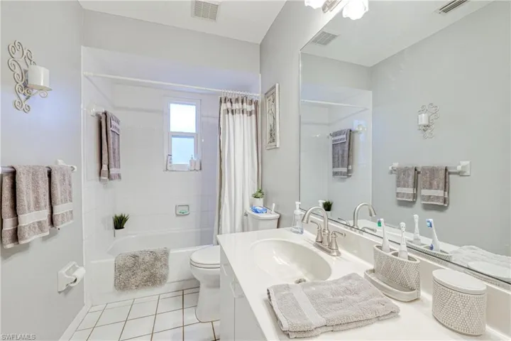 Full bathroom featuring vanity, toilet, tile patterned flooring, and shower / tub combo