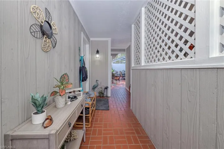 Hallway featuring wood walls
