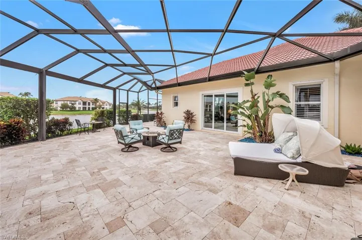Lanai Space between Home and Cabana, outdoor fireplace, sun bed, room for games, and grandchildren!